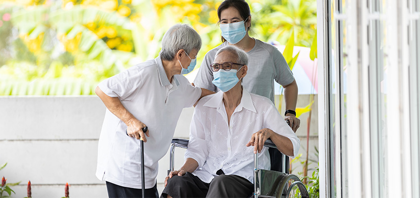 Seniors wearing masks with healthcare workers