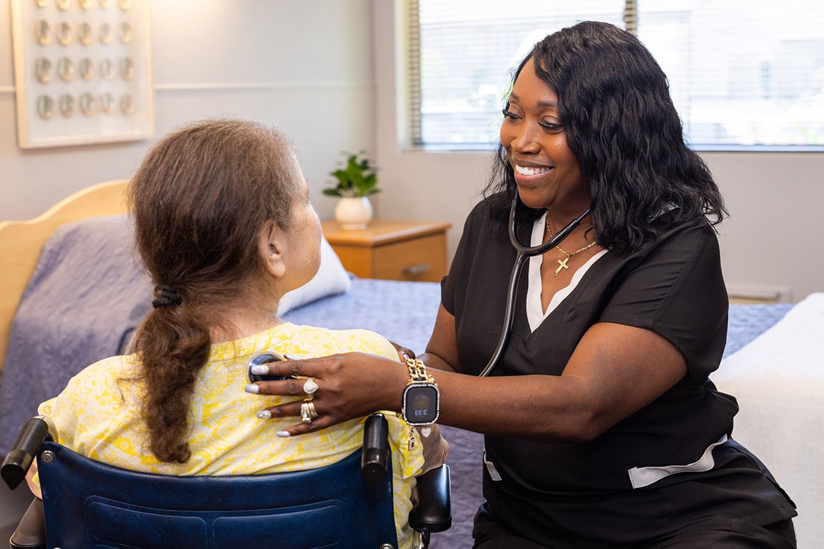 Nurse listening to patient's heartbeat at Johns Island Post Acute